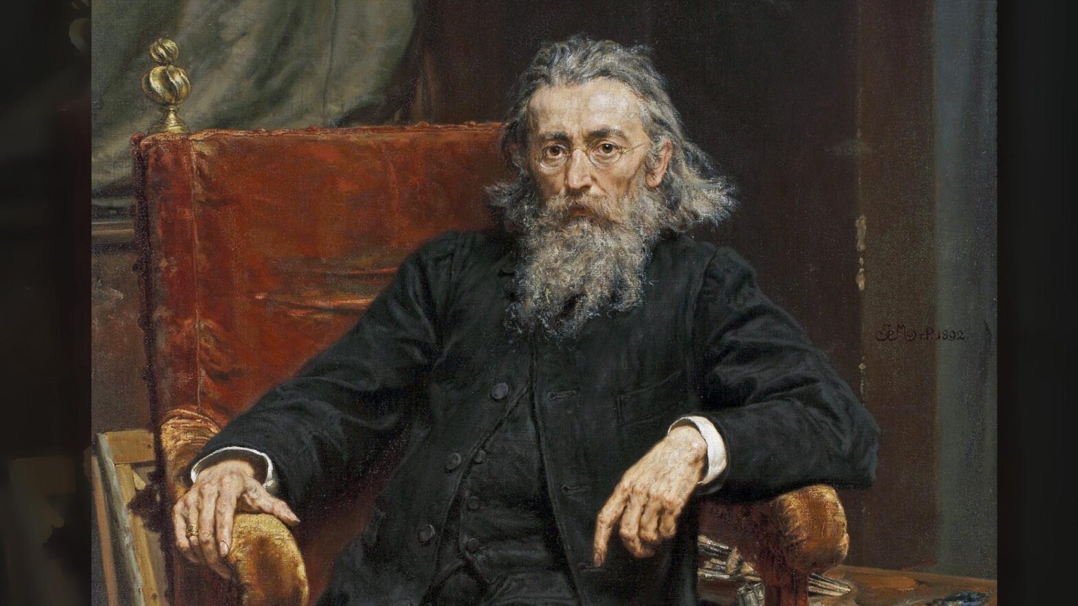 Obraz olejny Autoportret Jana Matejki. Starszy mężczyzna siedzi w fotelu, ma długą i zmierzwioną siwą brodę, dlugie włosy zaczesane do tyłu, z przodu lekko łysiejący. Ubrany jest w ciemnoszarą kamizelką i rozpięty surdut. Fotel jest obity brązową tkaniną